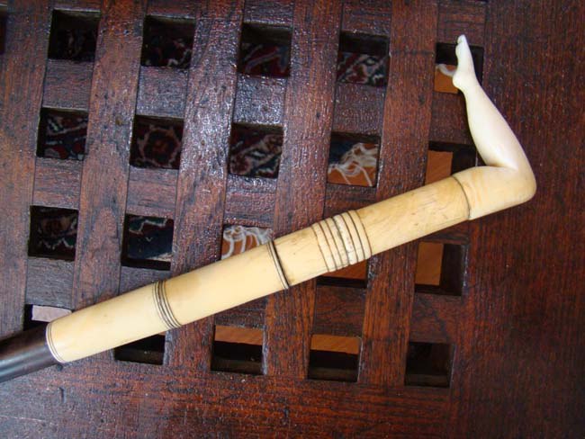 A fabulous 19th century Captain's walking stick having a carved whale ivory 'ladies leg' handle